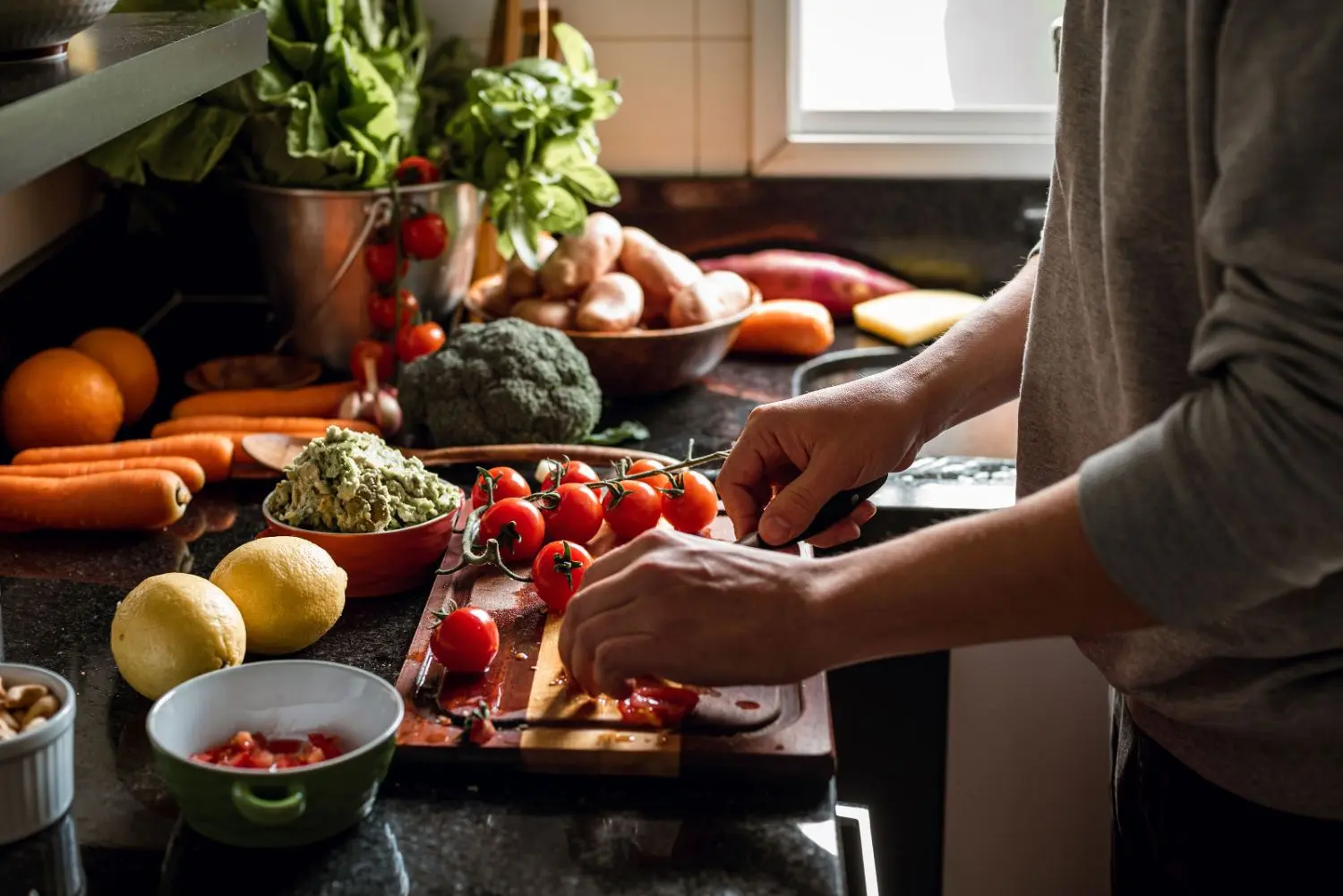 Man making vegan lunch from vegetables.