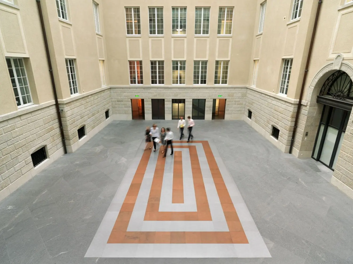 One hundred and thirty square aluminium panels encircle 99 copper panels, each placed flat on the floor in the middle of the central atrium of our headquarters.