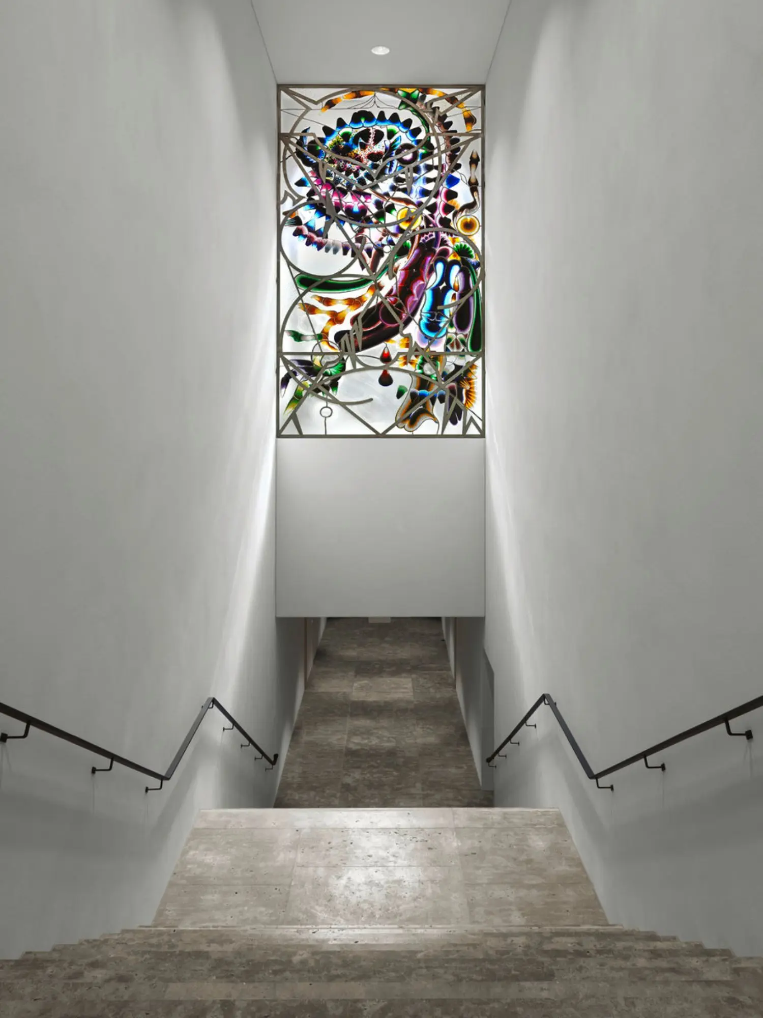 Artwork is located in the window above the staircase that leads down to the passage connecting the Altbau with Swiss Re Next.
