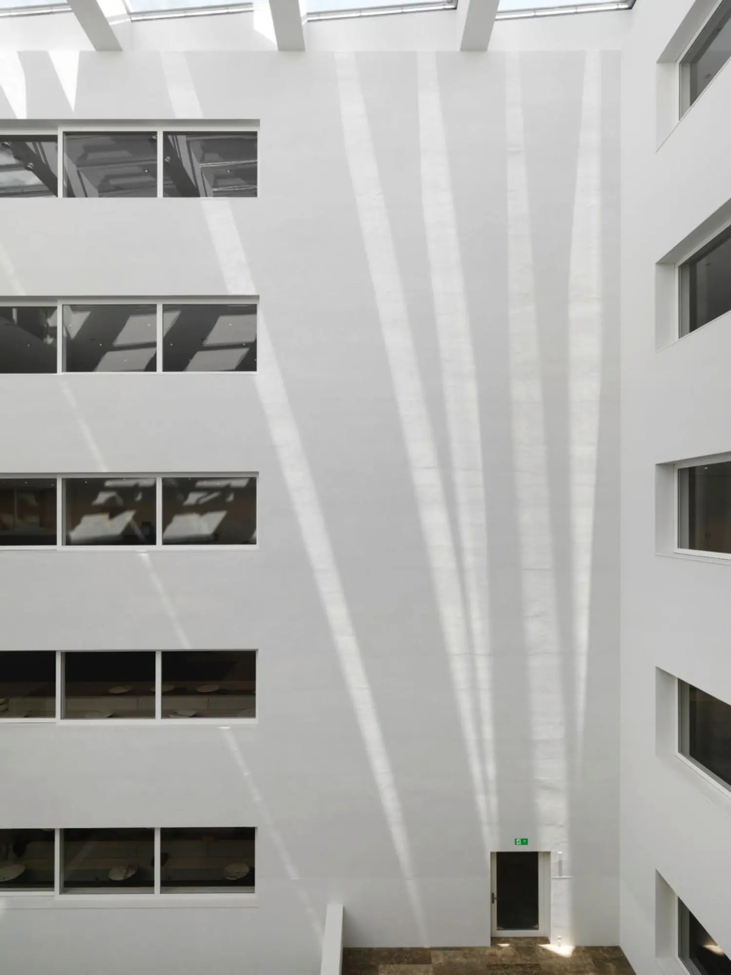 Parreno has installed a set of heliostats that track the movement of the sun and project its path for us to watch as it moves along the atrium walls.