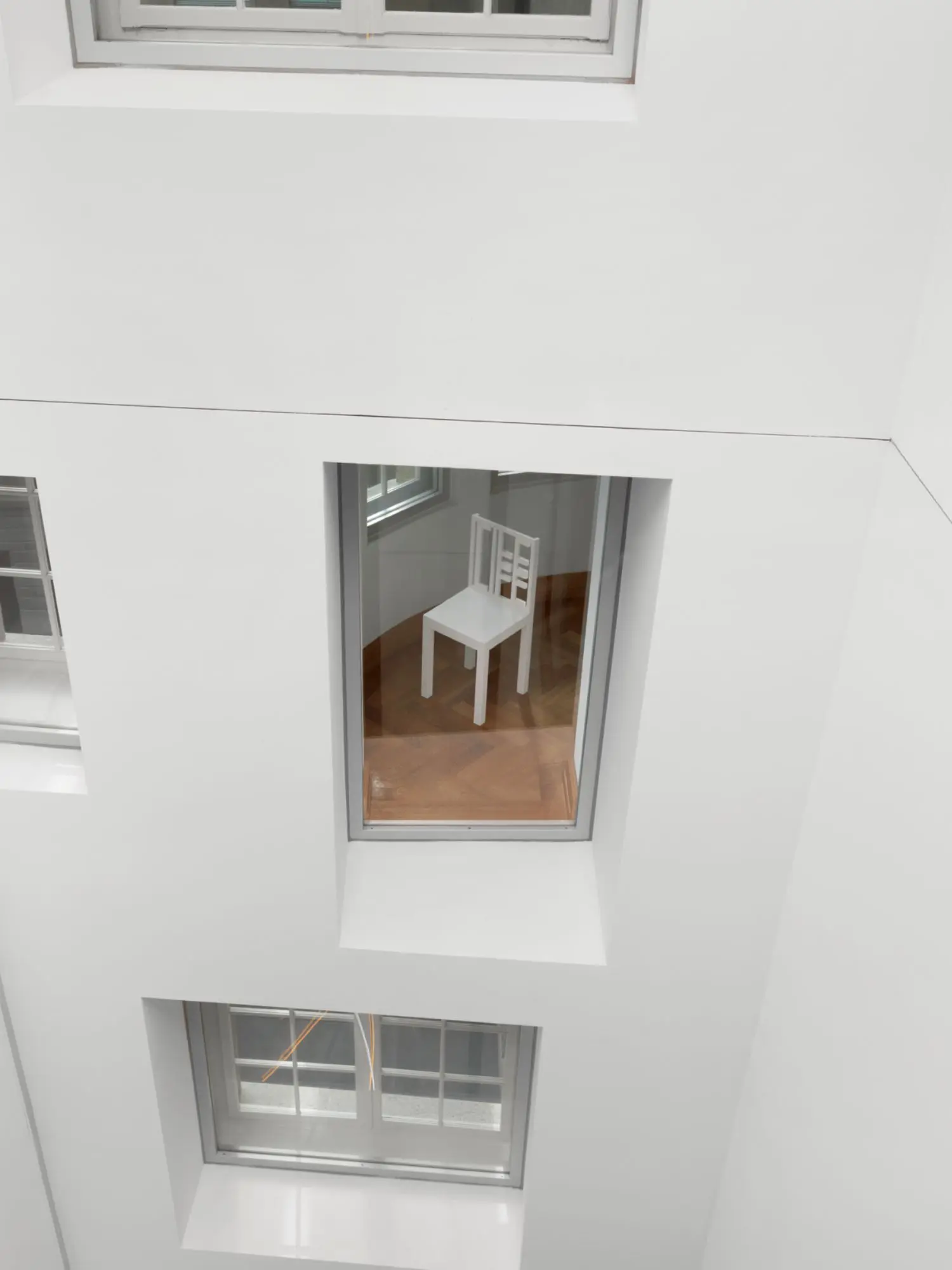 The chairs face the glass fronted alcoves that look onto the central lift shaft of our Zurich headquarters.