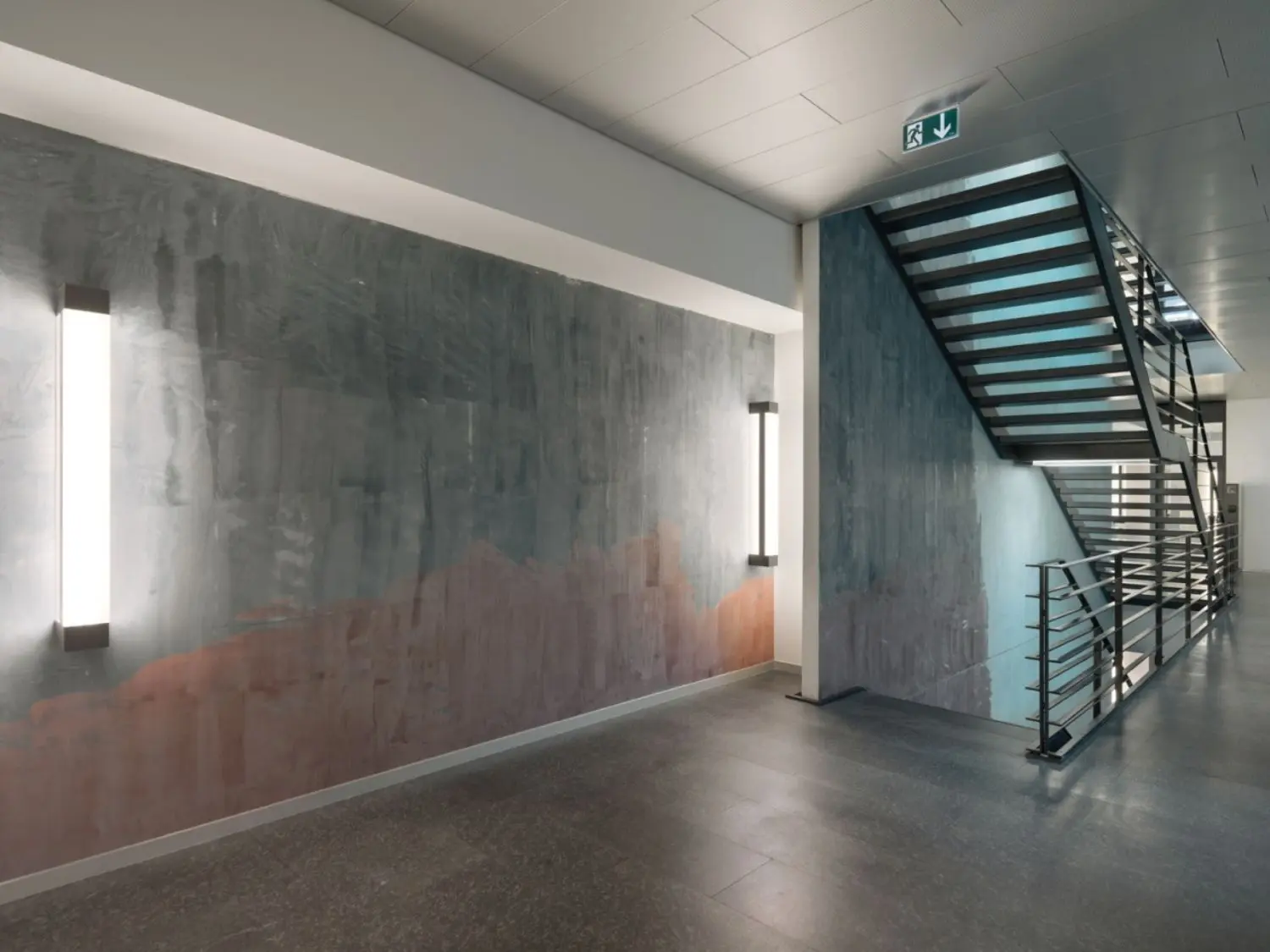 A bank of large windows cast rays of ever-changing light on the long sections of wall.