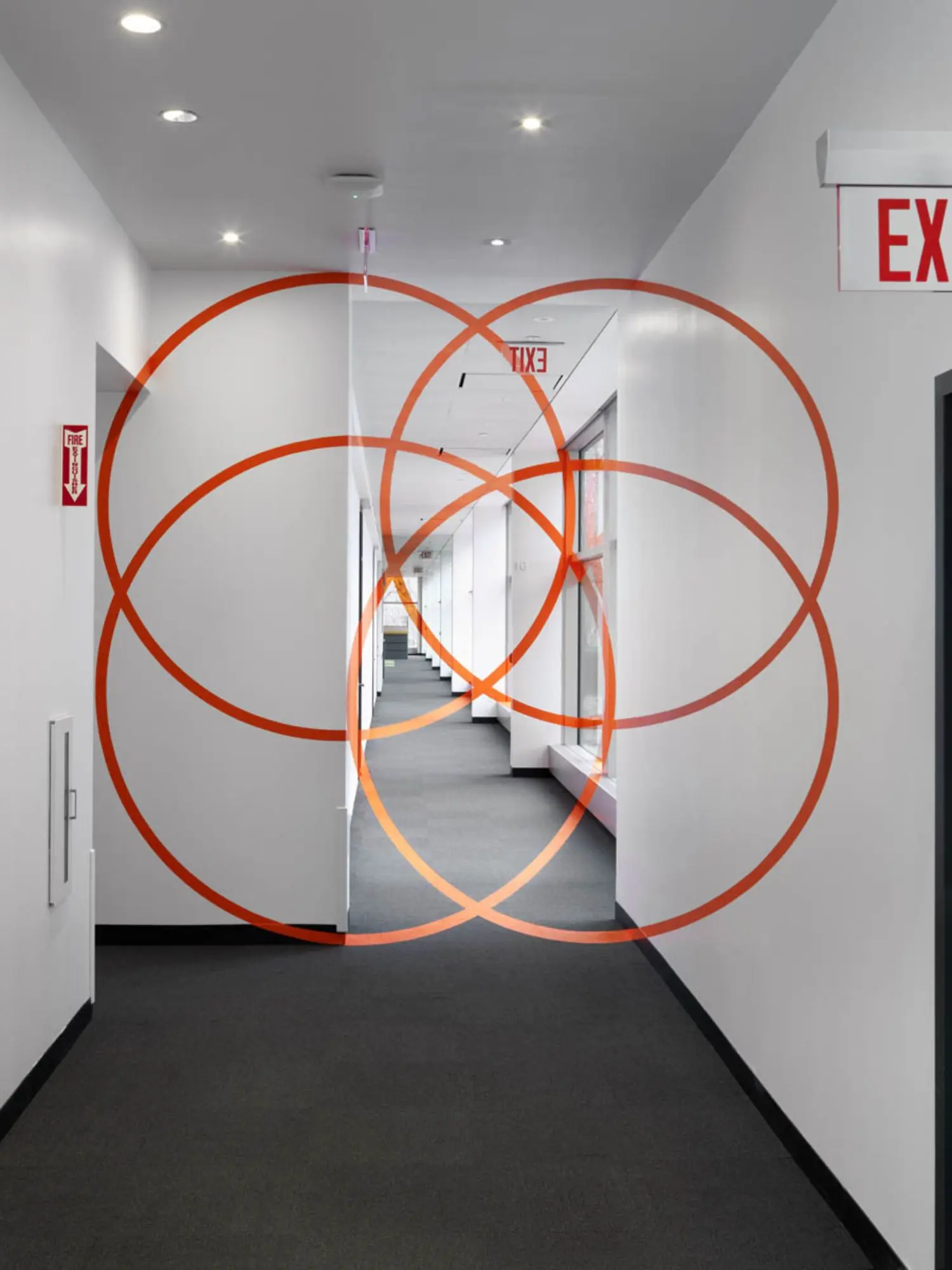 Just an illusion: from one particular point of view – it seems four interconnecting orange circles block one's passage though another corridor.