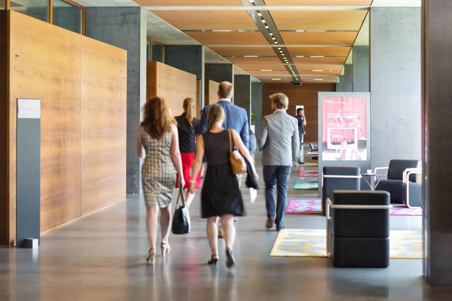 People walking down a hallway.